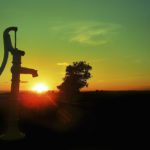 Old water pump. Sunset over the horizon of the sea.When: 22 Jul 2013