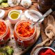 Closeup of raw ajvar on the table with vegetables and sauces on the background