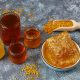 Various kinds of honey in glass jars,honeycomb and pollen.