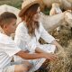 Family spending time together outside with a goat