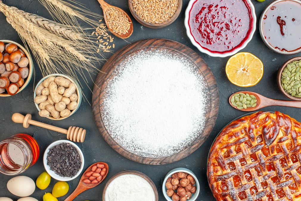 top-view-yummy-fruity-pie-with-flour-nuts-jam-dark-cookie-sweet-pie-sugar-cake-tea-pastry-dessert-biscuit